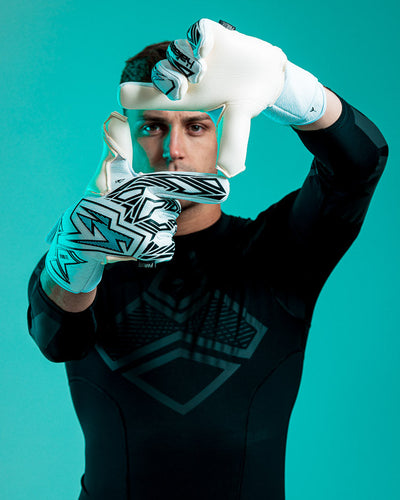 Person wearing Kaliaaer blue and white junior goalkeeper gloves