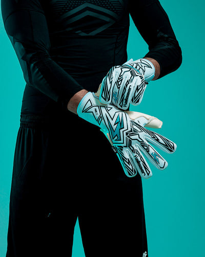 Person wearing Kaliaaer blue and white junior goalkeeper gloves