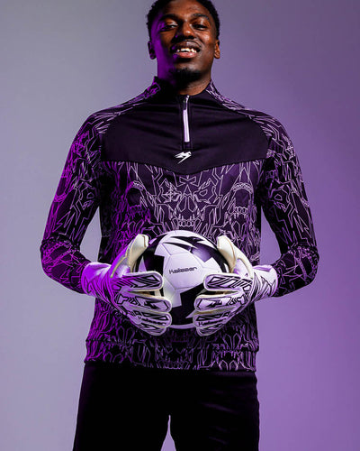 Person wearing the kaliaaer black and white secure cut goalkeeper gloves