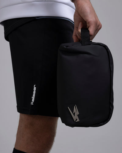 A person carrying the Kaliaaer Pro Glove Wash Bag.