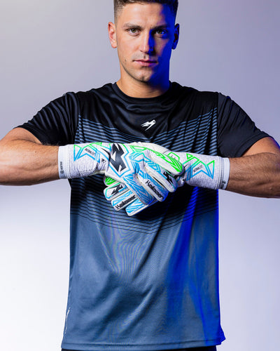boy wearing green and blue strapless goalie gloves