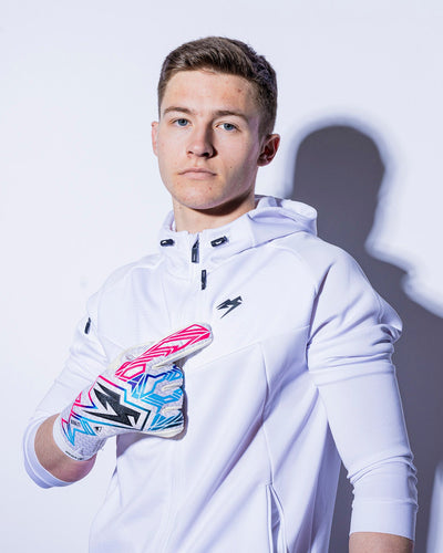 boy wearing junior strapless pink and blue goalkeeper gloves