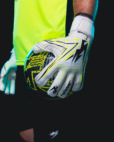Joe Hart wearing white Goalie gloves holding a football on his hip