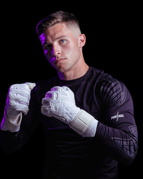 A person Showing the back of the kaliaaer white jack Butland GK gloves