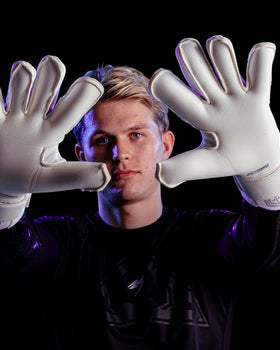 A person showing the palms of the Kaliaaer Jack Butland Goalkeeper Gloves in Junior Sizes