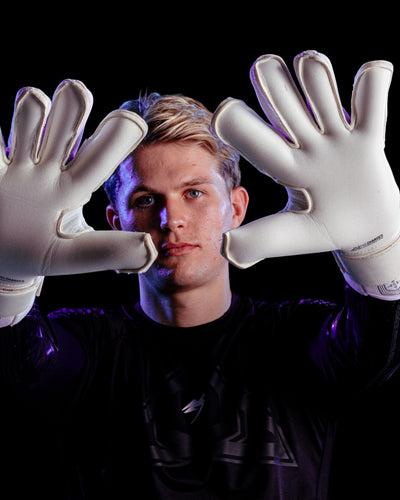 A person showing the palms of the Kaliaaer Jack Butland Goalkeeper Gloves in Junior Sizes