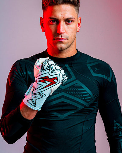person with fist clenched wearing Kaliaaer red and black goalkeeper gloves