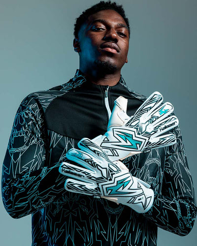 Person with 2 hands up wearing kaliaaer blue and white goalkeeper gloves