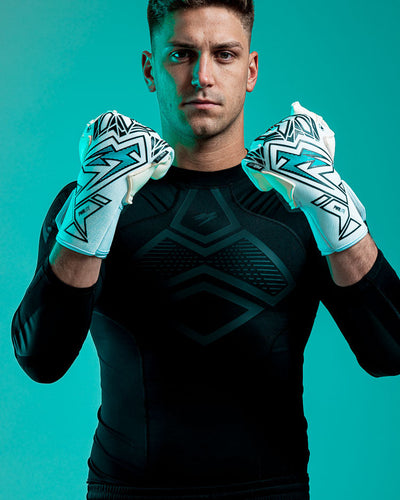 Person wearing Kaliaaer blue and white junior goalkeeper gloves