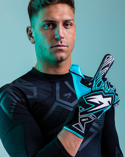 Person with 1 finger up wearing kaliaaer blue goalkeeper gloves