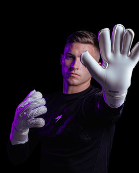 A person showing the palm of the JB kaliaaer white goalkeeper gloves