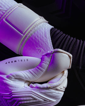 A person showing the wrist of the junior kaliaaer jack Butland white goalie gloves