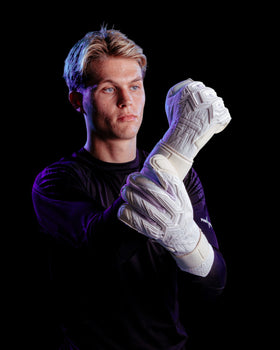 Person wearing white Kaliaaer Jack Butland junior GK gloves