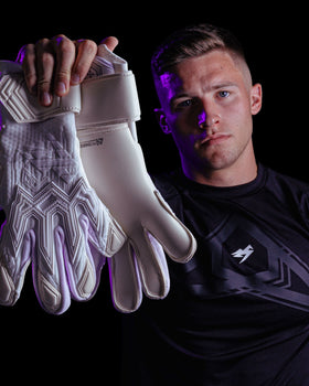 A person holding up the Kaliaaer Jack Butland Goalkeeper Gloves