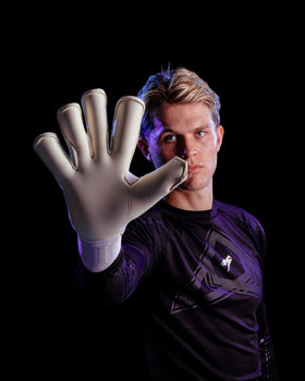 A person showing the palm of Kaliaaer goalkeeper gloves
