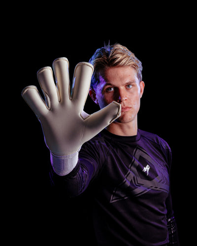 A person showing the palm of Kaliaaer goalkeeper gloves