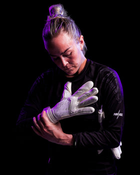 A person trying on kaliaaer white goalie gloves