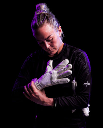 A person trying on kaliaaer white goalie gloves