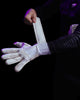 A person fastening the wrists of Kaliaaer white goalkeeper gloves