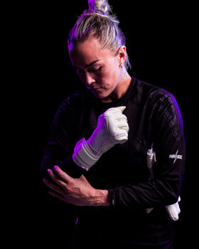 A person wearing kaliaaer white latex goalkeeper gloves