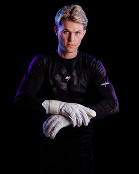 Person wearing white Kaliaaer Jack Butland junior goalkeeper gloves