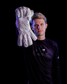A person holding up the kaliaaer pwrpro goalkeeper gloves