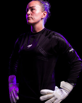 A person wearing kaliaaer white latex backhand goalkeeper gloves