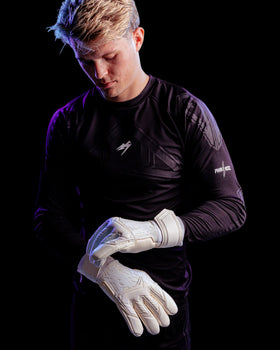 A person wearing kaliaaer whiteout latex goalkeeper gloves