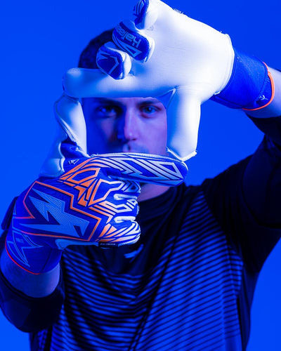 Man with Kaliaaer Goalkeeper Gloves holds hands towards screen