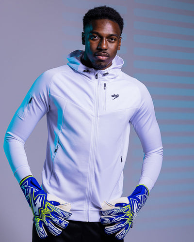 person wearing Kaliaaer Azure goalkeeper gloves with hands on hips