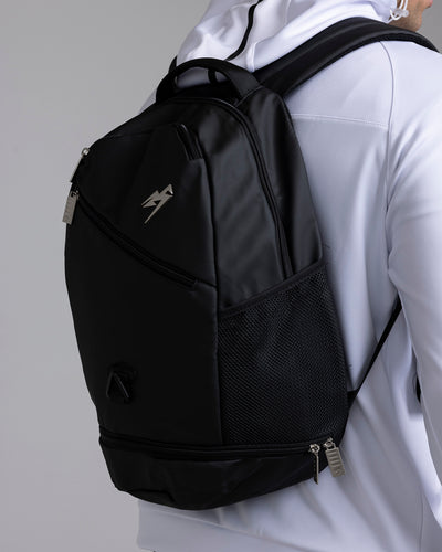 A person wearing the Kaliaaer Pro Backpack in black.