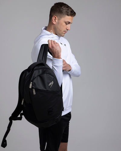 A person putting on the Kaliaaer Pro Backpack.