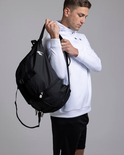 A person putting on the Kaliaaer Pro Travel bag.