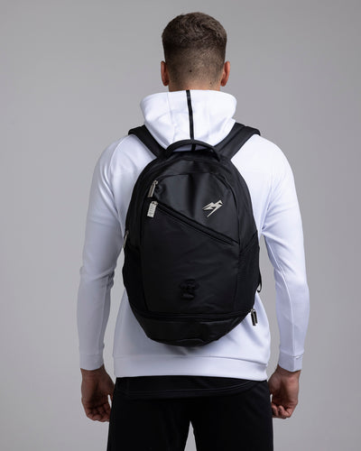 A person wearing the Kaliaaer Pro Backpack in black.