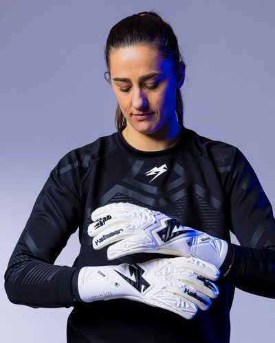 person holding strapless kaliaaer white goalkeeper gloves
