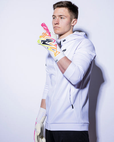 boy wearing strapless pink and neon junior goalie gloves