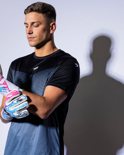 man wearing kaliaaer pink blue and black strapless goalie gloves