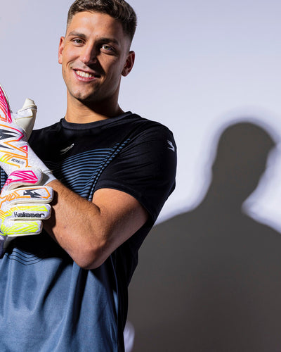 boy wearing strapless neo and pink junior goalkeeper gloves