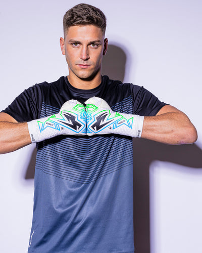 man wearing kaliaaer strapless green and blue goalkeeper gloves