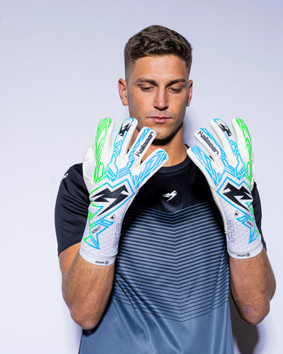 Man wearing green and blue strapless goalie gloves