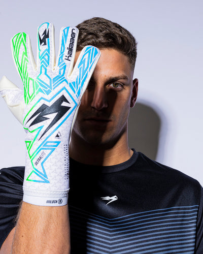 Man hold kaliaaer strapless goalie gloves inform of face