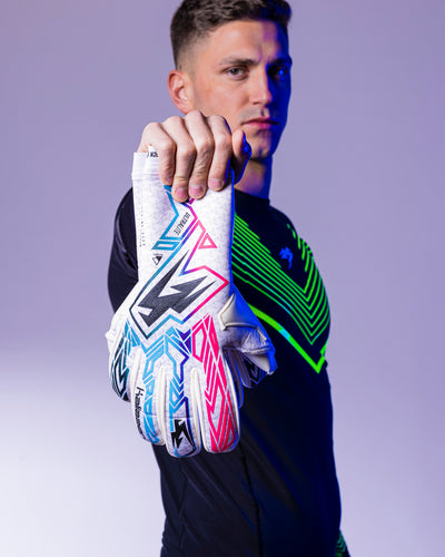 person holding pink blue and black Kaliaaer goalkeeper gloves