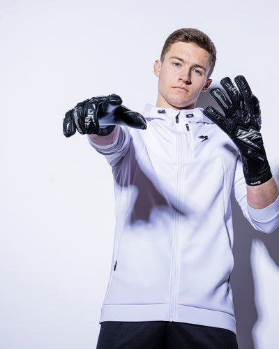 person wearing black and silver kaliaaer strapless goalkeeper gloves