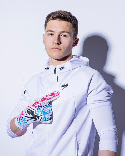 man wearing pink blue and black kaliaaer goalie gloves