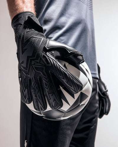 Person wearing Black Roll finger goalkeeper gloves