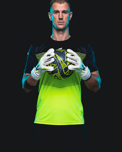 Joe Hart wearing Kaliaaer white and Neo goalkeeper gloves holding a football