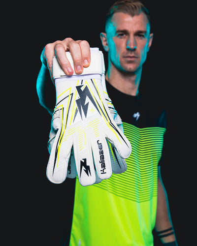 Joe Hart holding up the White with Neo Goalkeeper Gloves