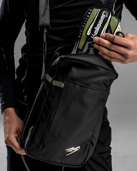 A person putting goalkeeper gloves into the Kaliaaer Pro Glove bag.